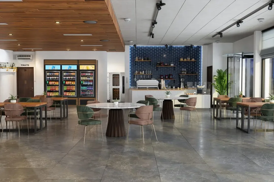 Modern office breakroom with vending machines, a coffee bar, and seating